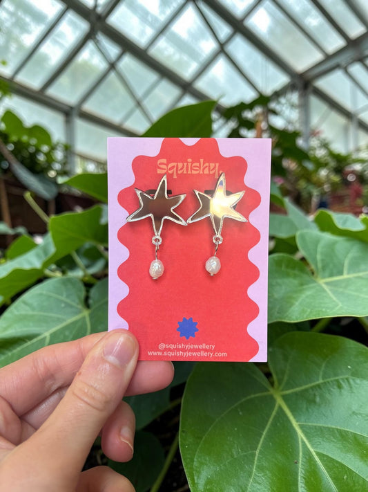 Abstract acrylic star earrings with real pearl drops inspired by modern art and museum gift shop jewellery.