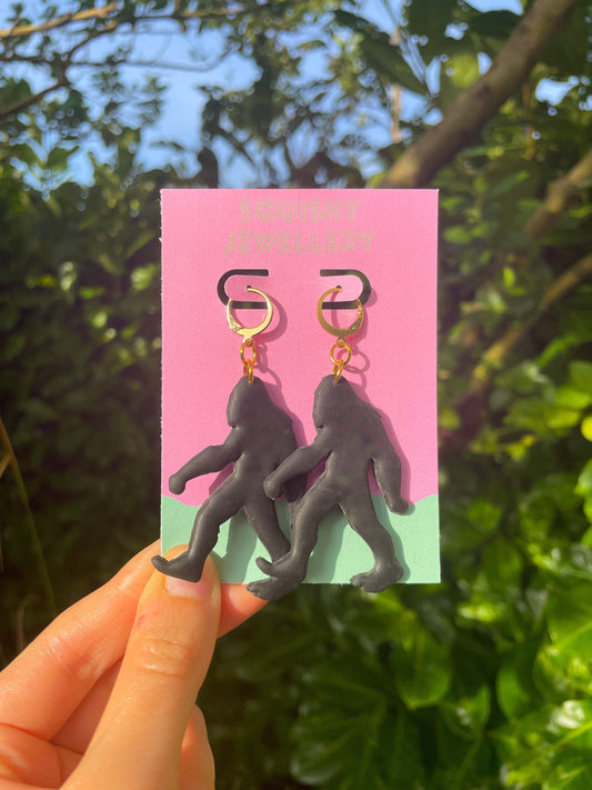 Black Bigfoot Monster Earrings Polymer Clay Horror Cryptid-Inspired Gold Huggie Hoops, Spooky Cute Goth Kitsch Conspiracy Gift